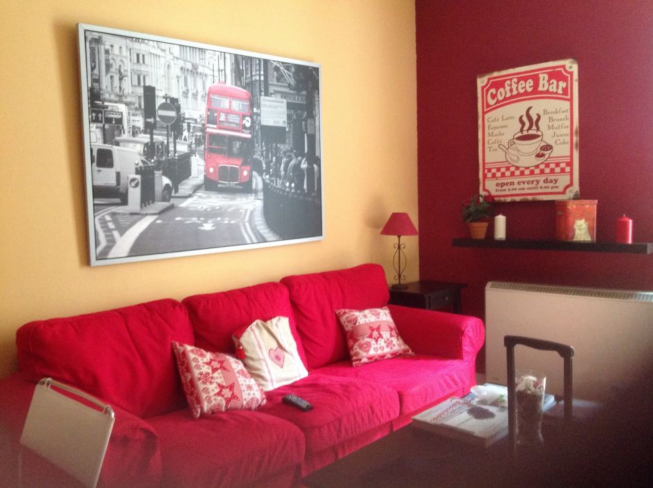 Our Madrid airbnb room with red couch- perfect! How to visit madrid and enjoy like locals guide