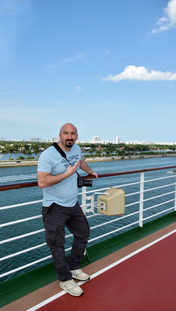 man posing on cruise ship against Florida landscape