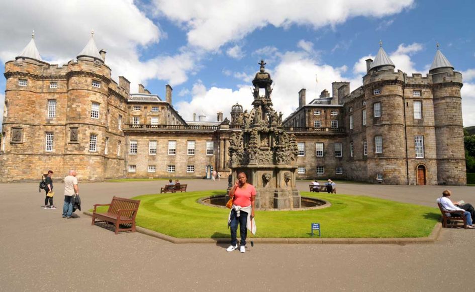 lady in fron of holyrood palace or palace of holyroodhouse