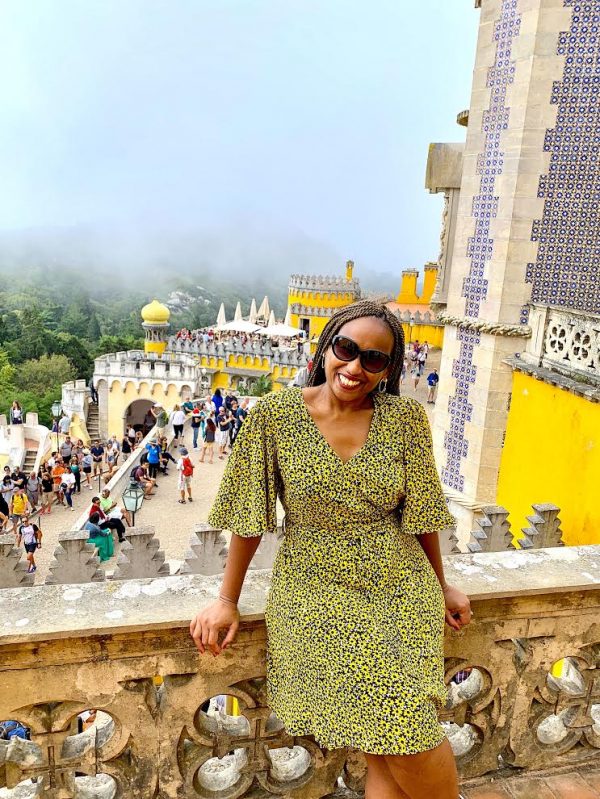 Lockdown And Life Stories With Dr. White 7 black woman in braids green dress with Sintra castle in the background