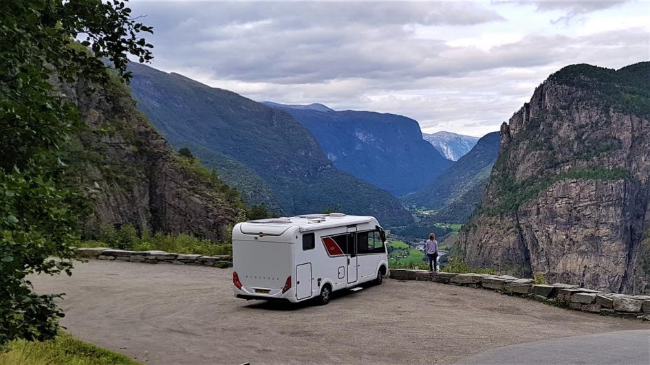 Travel In Asia During The Pandemic - Gilda Baxter 5 rv van parked with mountain views and woman posing