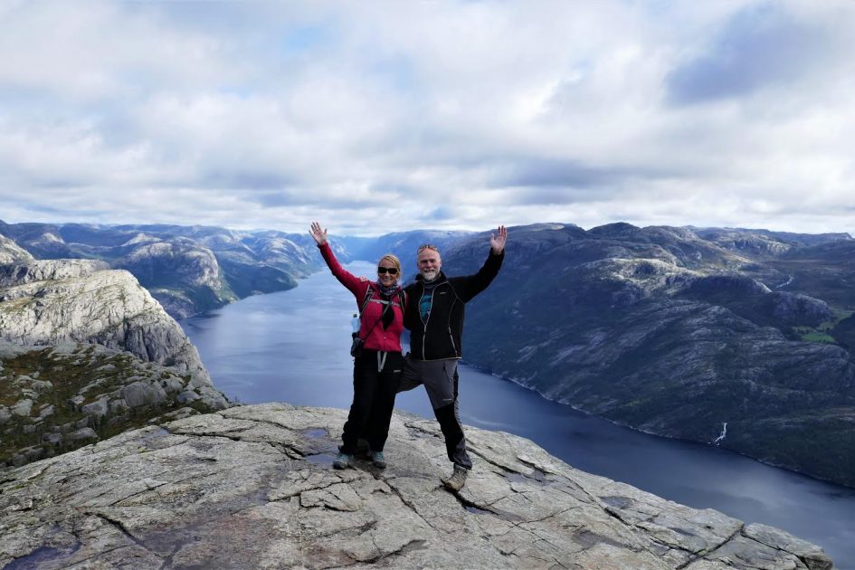 Travel In Asia During The Pandemic - Gilda Baxter 3 couple in northern Europe with mountain and water view behind themh