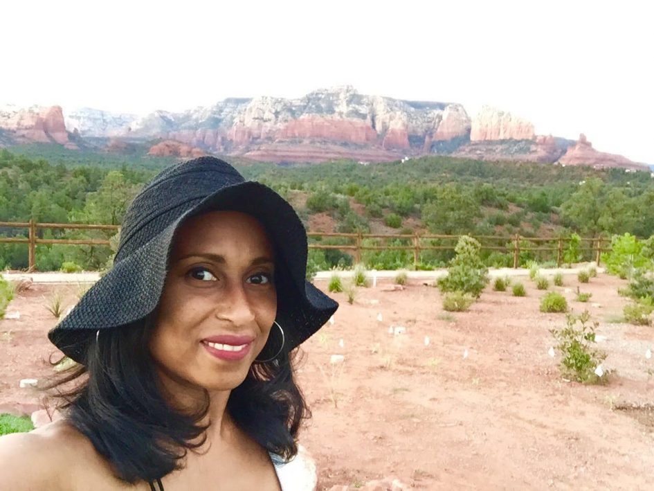 Lockdown And Life Stories With Dr. White 8 woman with red rocks in the background wearing black sun hat