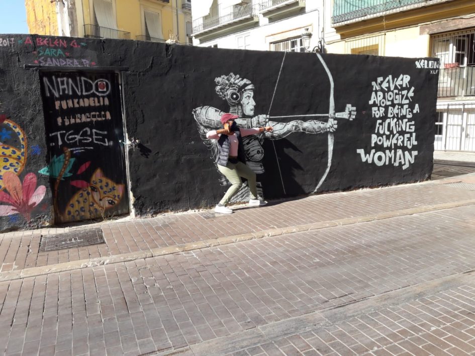 black graffiti wall of commuter expat now retired in spain firing arrow