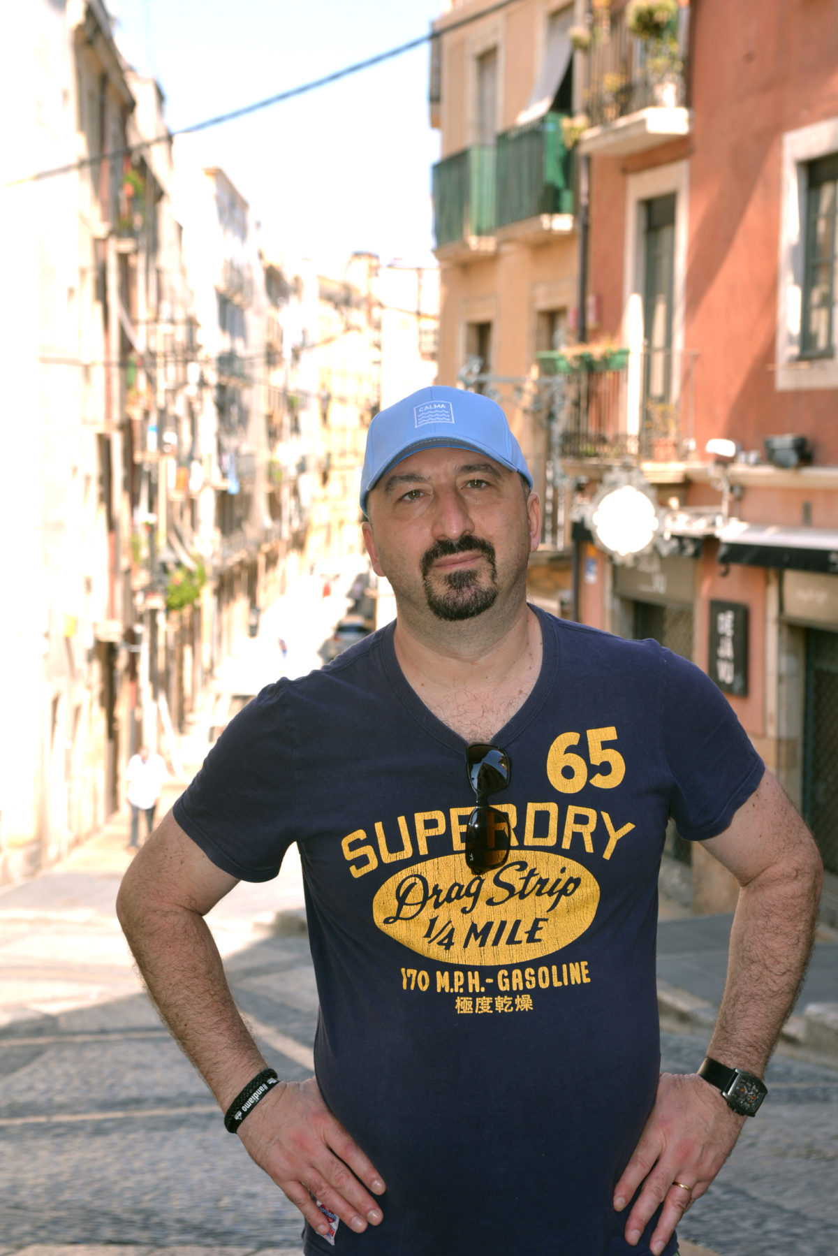 man in old town tarragona spain portrait blue tshirt and hat